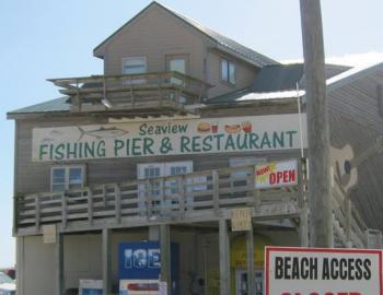 Image from Seaview Pier Restaurant's Facebook page a tall, wooden building with a sign that reads "Seaview Fishing Pier & Restaurant" in green text